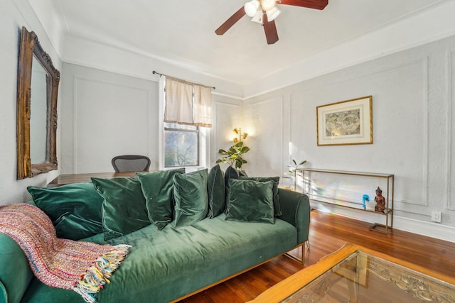 living room featuring hardwood / wood-style floors and ceiling fan