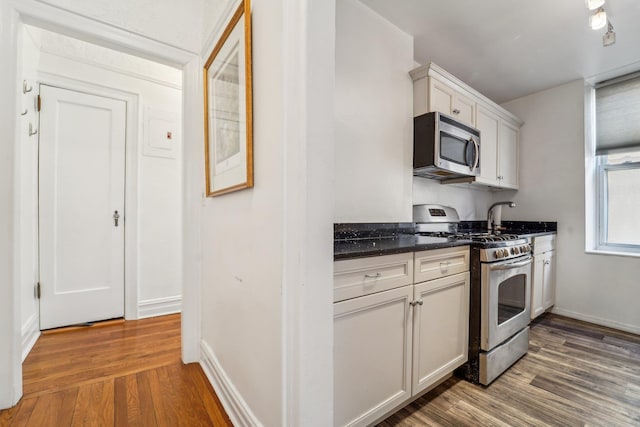 kitchen with white cabinetry, dark hardwood / wood-style flooring, and stainless steel appliances