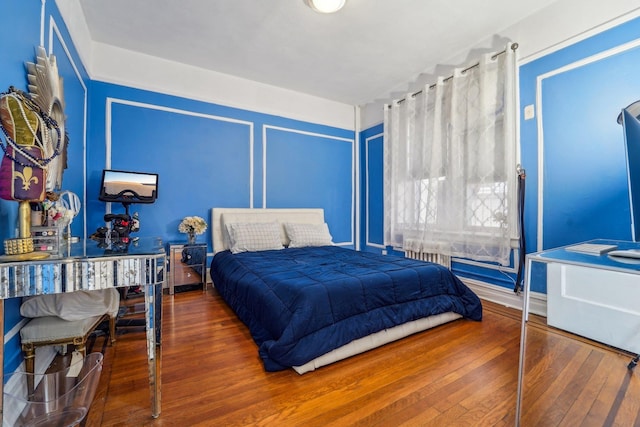 bedroom with wood-type flooring