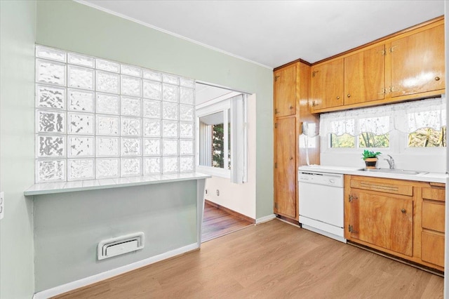 kitchen featuring sink, crown molding, light hardwood / wood-style floors, and dishwasher