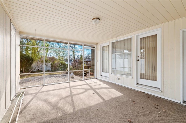 unfurnished sunroom featuring wood ceiling