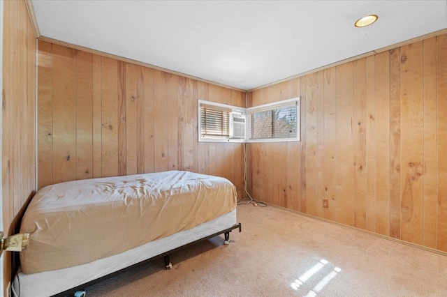 carpeted bedroom with wooden walls