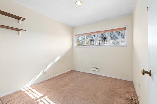 unfurnished room featuring light carpet