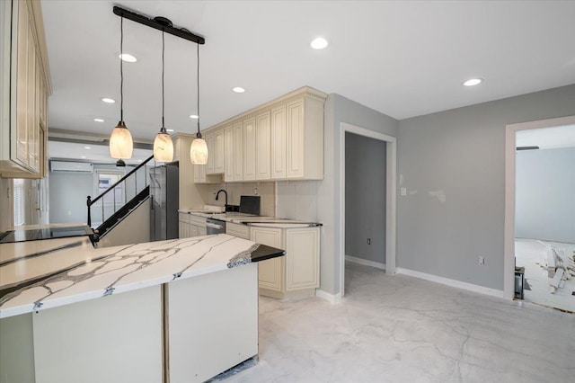 kitchen featuring stainless steel appliances, cream cabinets, light stone countertops, decorative light fixtures, and kitchen peninsula