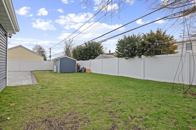 view of yard featuring a storage unit and a patio area