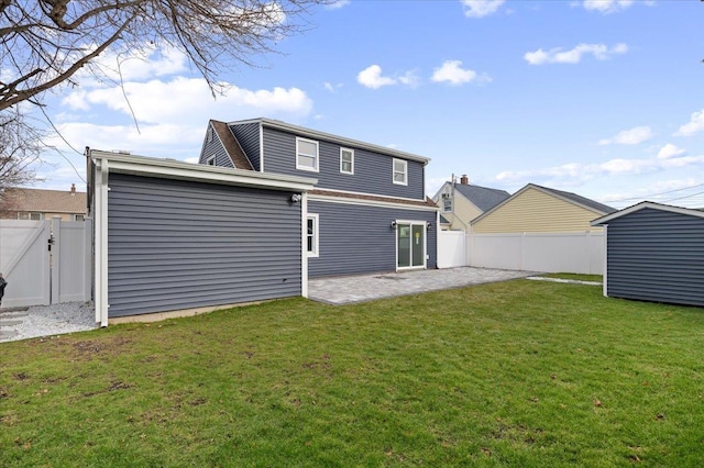 back of house with a yard and a patio