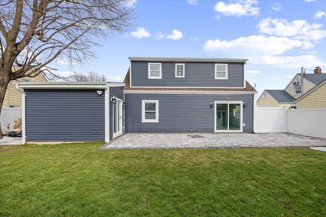 rear view of house featuring a patio and a lawn