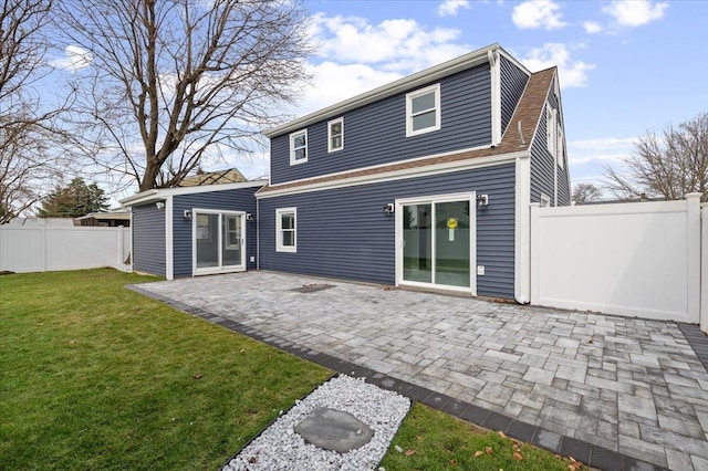 back of house featuring a yard and a patio area