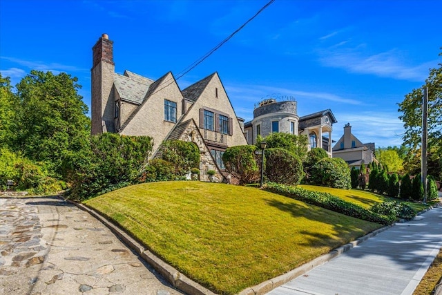 240-25 Alameda Ave, Douglaston, NY 11362 - view of front of house featuring a front yard, stucco siding, and a chimney