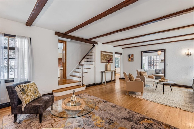 240-25 Alameda Ave, Douglaston, NY 11362 - living room featuring a textured wall, stairway, wood-type flooring, and beamed ceiling