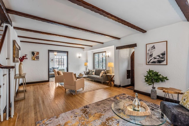240-25 Alameda Ave, Douglaston, NY 11362 - living room with beamed ceiling, baseboards, a textured wall, and hardwood / wood-style flooring