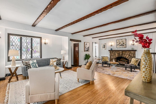 240-25 Alameda Ave, Douglaston, NY 11362 - living area with wood-type flooring, a stone fireplace, and beam ceiling