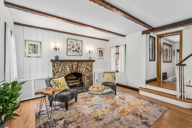 240-25 Alameda Ave, Douglaston, NY 11362 - interior space featuring wood finished floors, a stone fireplace, beam ceiling, and stairway