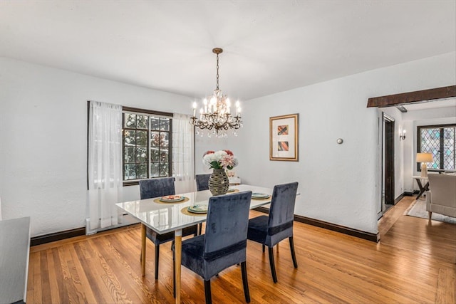 240-25 Alameda Ave, Douglaston, NY 11362 - dining area featuring light wood-type flooring, an inviting chandelier, and baseboards