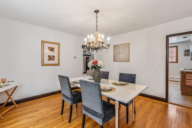 240-25 Alameda Ave, Douglaston, NY 11362 - dining room featuring a chandelier, light wood-type flooring, a baseboard heating unit, and baseboards