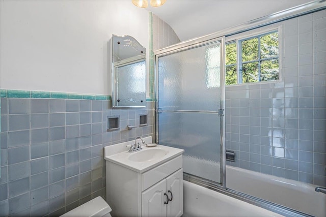 240-25 Alameda Ave, Douglaston, NY 11362 - full bathroom with combined bath / shower with glass door, tile walls, vanity, and wainscoting