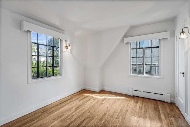 240-25 Alameda Ave, Douglaston, NY 11362 - additional living space featuring a baseboard heating unit, baseboards, and wood finished floors