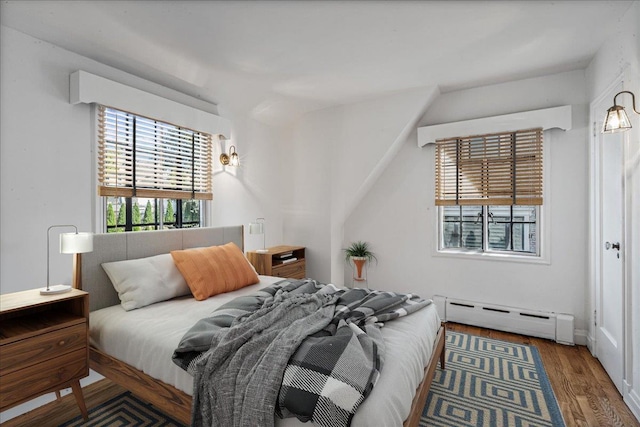 240-25 Alameda Ave, Douglaston, NY 11362 - bedroom with a baseboard heating unit and wood finished floors