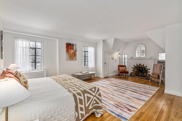 240-25 Alameda Ave, Douglaston, NY 11362 - bedroom featuring baseboards, hardwood / wood-style floors, and a brick fireplace