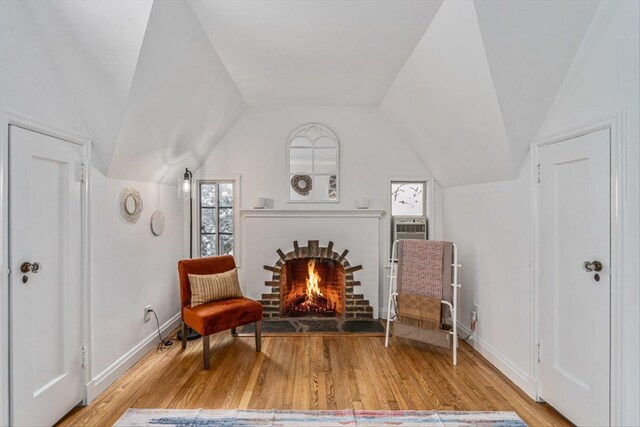 240-25 Alameda Ave, Douglaston, NY 11362 - sitting room with baseboards, wood finished floors, a fireplace, and vaulted ceiling
