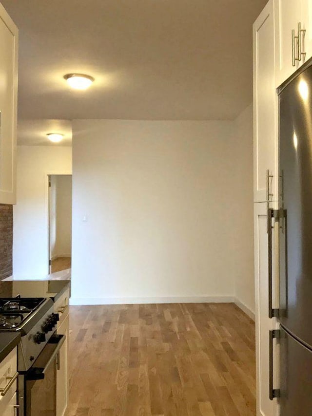 kitchen with white cabinetry, light hardwood / wood-style flooring, and stainless steel appliances