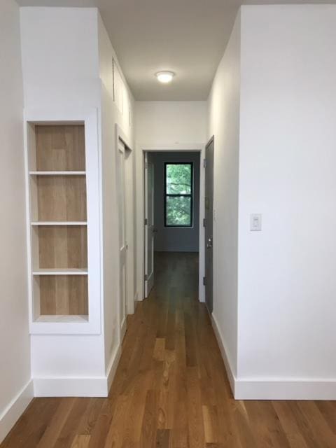 hallway with wood-type flooring