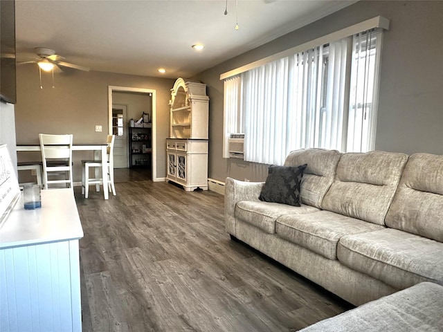 living room featuring a baseboard heating unit, dark wood-type flooring, and ceiling fan