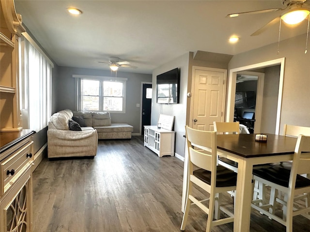 dining area with ceiling fan and dark hardwood / wood-style flooring