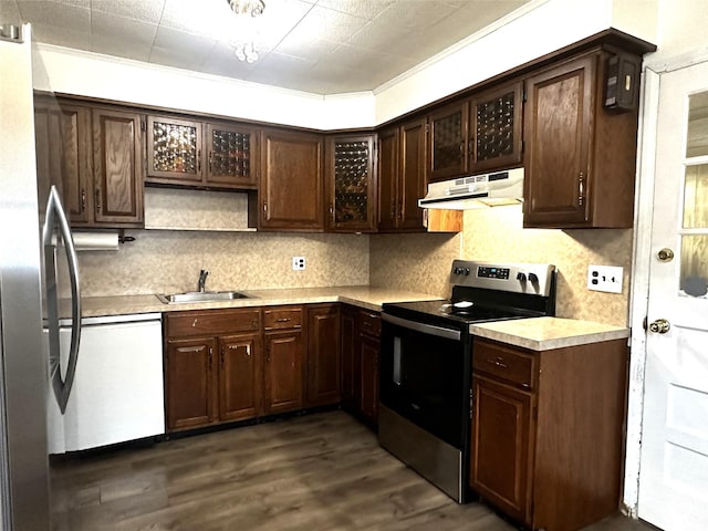 kitchen with dark brown cabinetry, sink, appliances with stainless steel finishes, dark hardwood / wood-style floors, and decorative backsplash