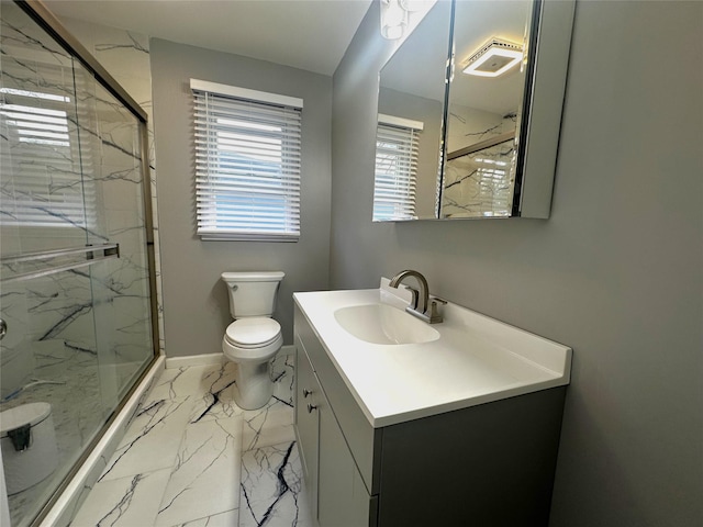 bathroom with walk in shower, vanity, and toilet