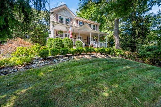 view of front of property featuring a front lawn and covered porch