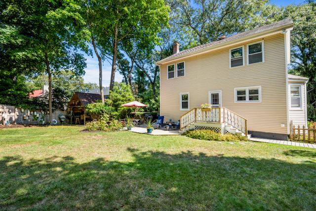 back of house with a patio and a yard