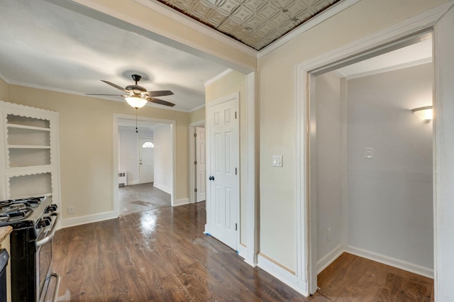 kitchen with radiator, crown molding, ceiling fan, dark hardwood / wood-style floors, and stainless steel gas range oven