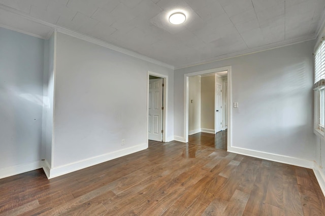 unfurnished room featuring crown molding and dark wood-type flooring