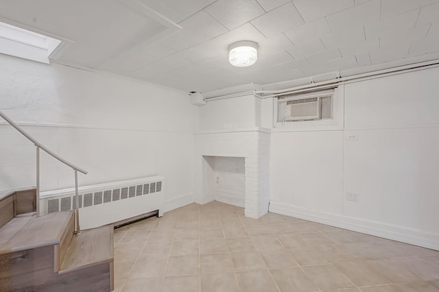 basement featuring radiator and a wall unit AC