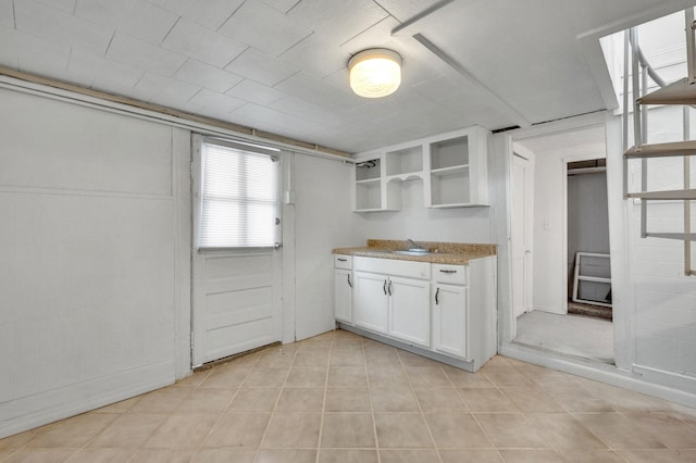 kitchen featuring sink and white cabinets