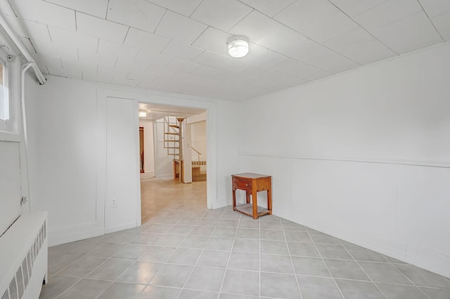 tiled spare room with radiator