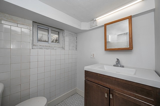 bathroom featuring vanity, tile patterned floors, and toilet