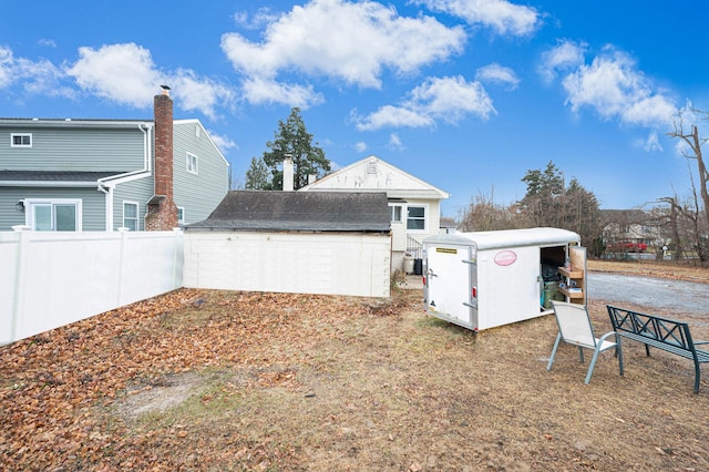 back of property featuring a shed