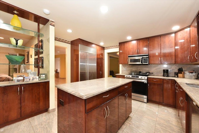 kitchen with stainless steel appliances, backsplash, a center island, light stone countertops, and recessed lighting