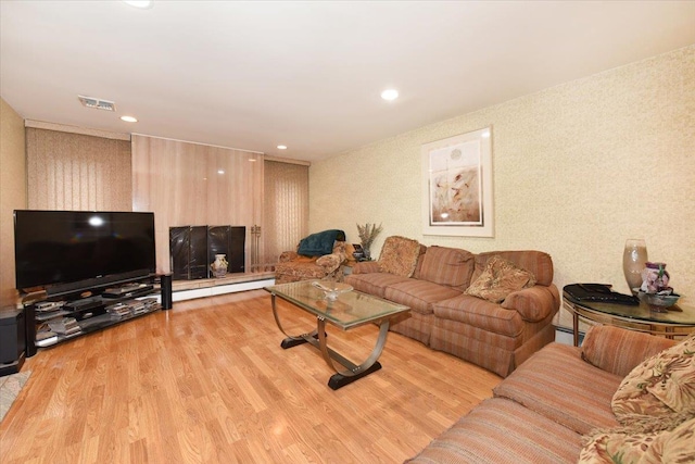 living room with wood finished floors, recessed lighting, and a baseboard radiator