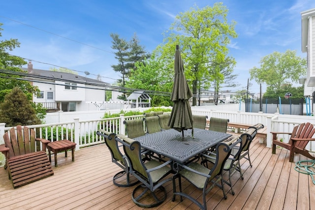 deck with outdoor dining area and a fenced backyard