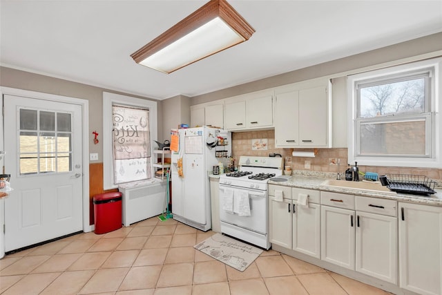 kitchen featuring white cabinetry, white appliances, decorative backsplash, and a wealth of natural light