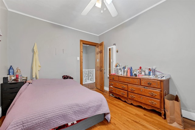 bedroom with a baseboard heating unit, crown molding, light hardwood / wood-style flooring, and ceiling fan