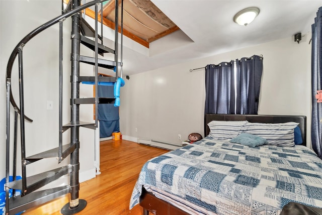 bedroom featuring a baseboard radiator and wood-type flooring