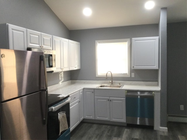 kitchen featuring lofted ceiling, stainless steel appliances, sink, and white cabinets