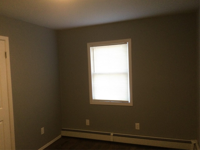 spare room featuring a baseboard heating unit