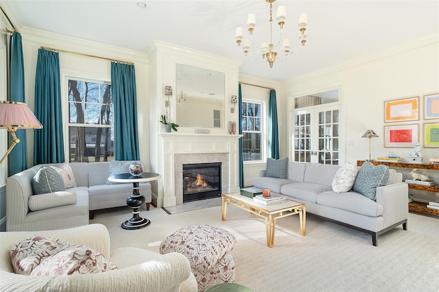 living room featuring a notable chandelier, a fireplace, and ornamental molding