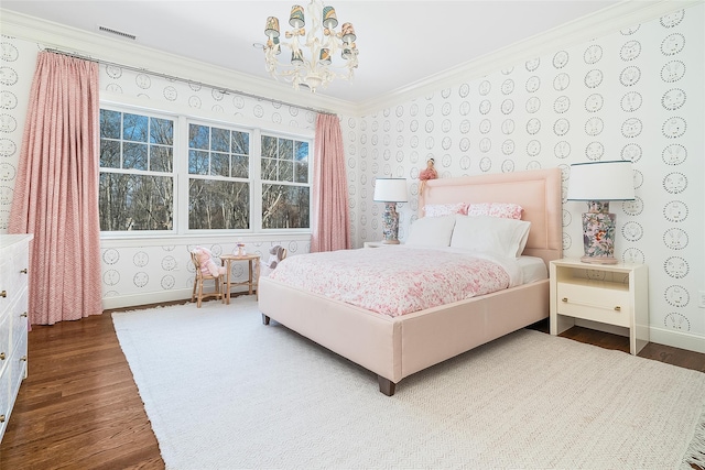 bedroom with an inviting chandelier, crown molding, and hardwood / wood-style flooring