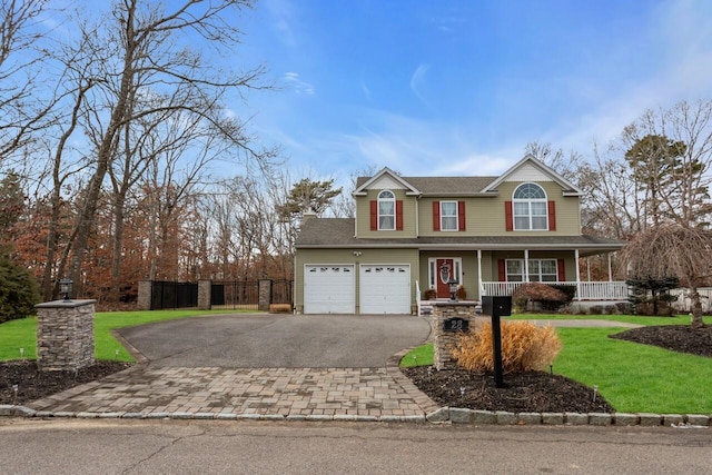 view of front of house with a porch, a garage, and a front lawn